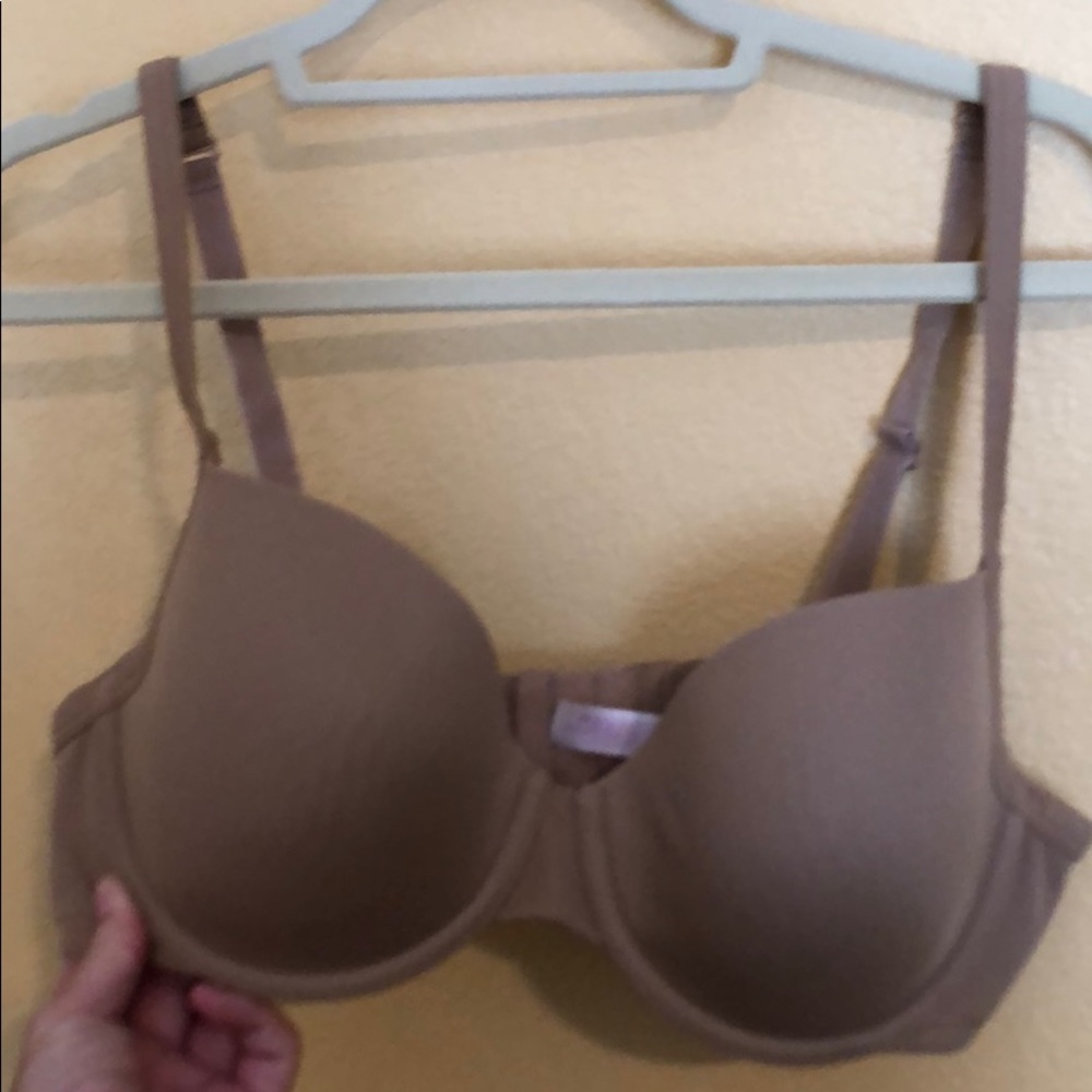 A gently worn beige bra by Cacique Intimates.